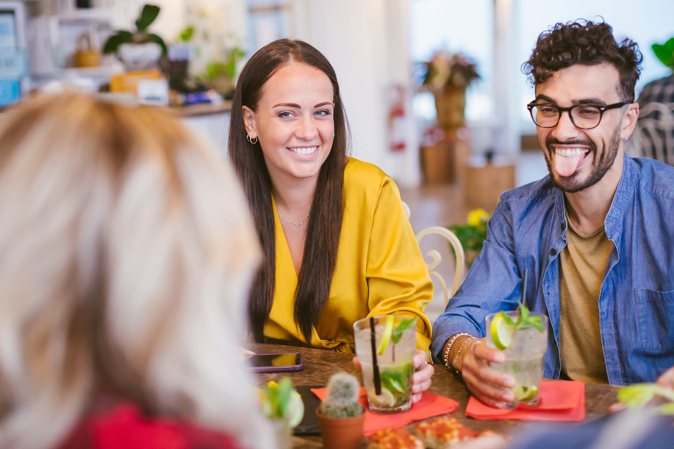 People drinking and eating at restaurant