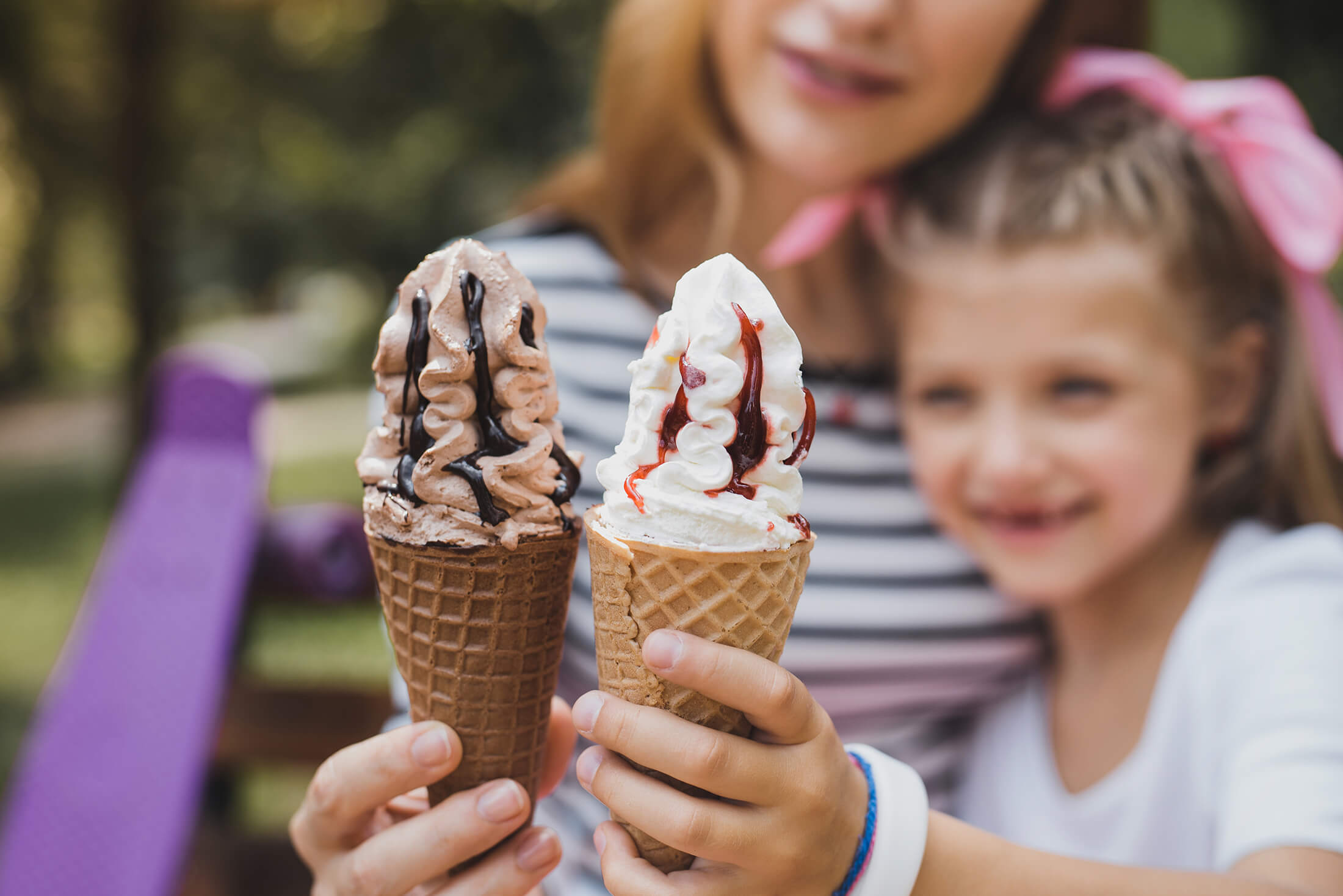 Kid and mother eating ice cream cones