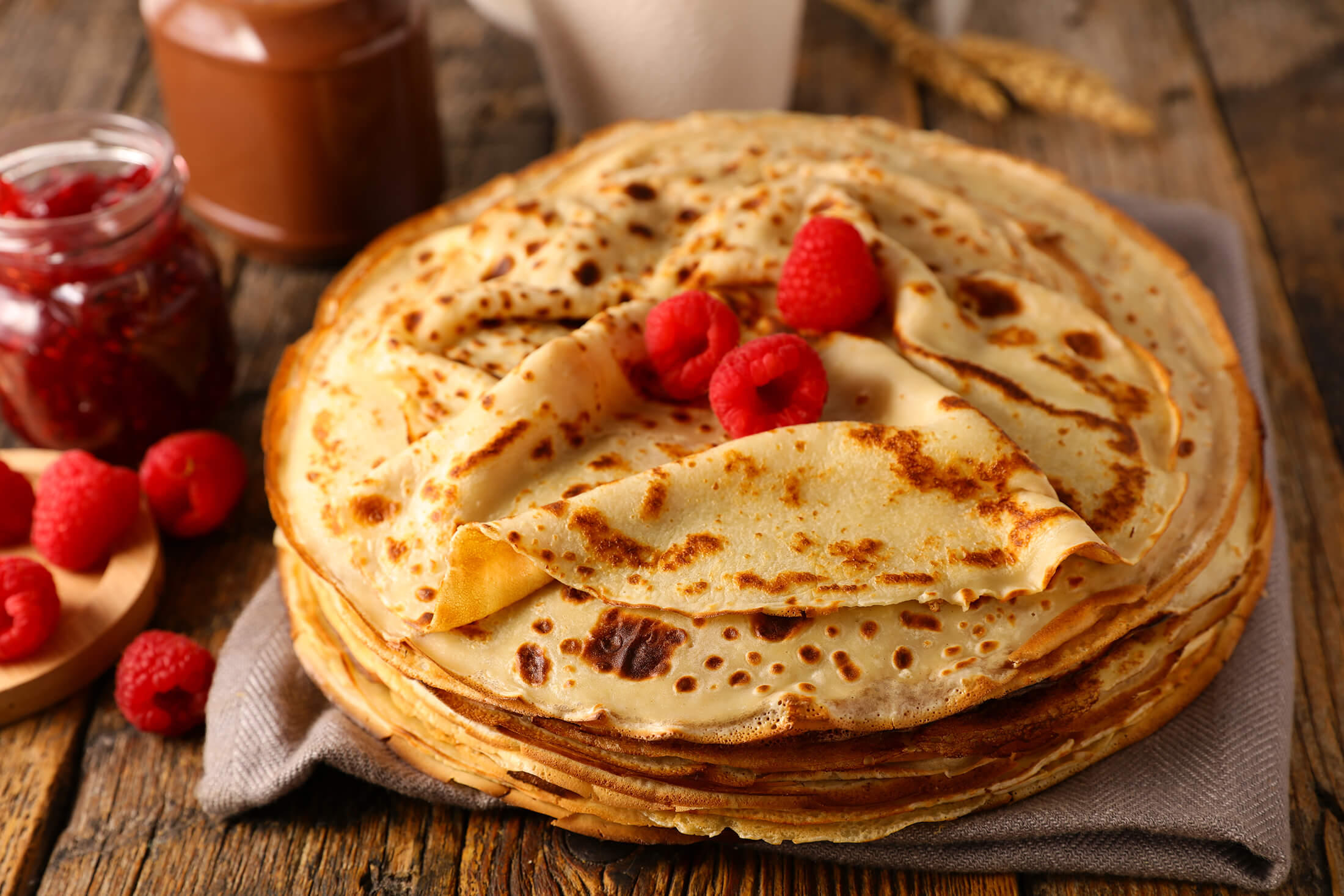 Stack of crepes with raspberries on top